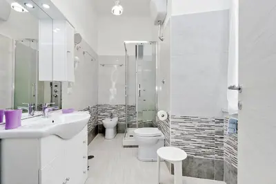 a bathroom with a sink and a toilet and a shower at GEMMA DOMUS in Rome