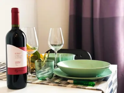a bottle of wine and two glasses on a table at Romantico appartamento a Trastevere in Rome