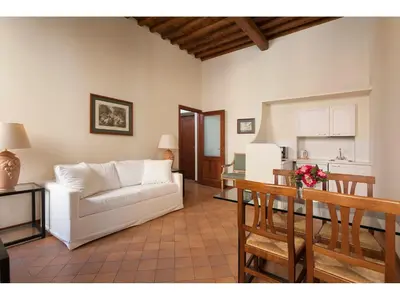 a living room with a white couch and a table at Rasella Suites 47 in Rome