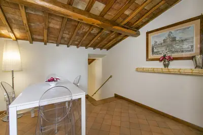 a dining room with a white table and chairs at Rasella Suites 47 in Rome