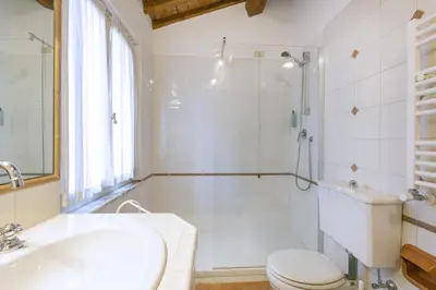 a bathroom with a shower and a toilet and a sink at Rasella Suites 47 in Rome