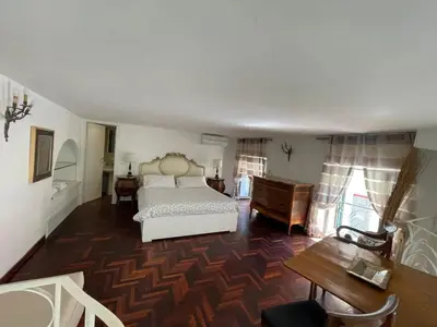 a bedroom with a bed and a wooden floor at Comfortable Apartment in the Heart of Rome, 65m², City View in Rome