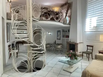 a spiral staircase in a living room with a table at Comfortable Apartment in the Heart of Rome, 65m², City View in Rome
