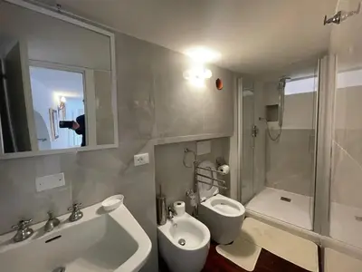 a person taking a picture of a bathroom at Comfortable Apartment in the Heart of Rome, 65m², City View in Rome