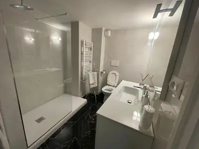 a bathroom with a sink and a shower and a toilet at Comfortable Apartment in the Heart of Rome, 65m², City View in Rome