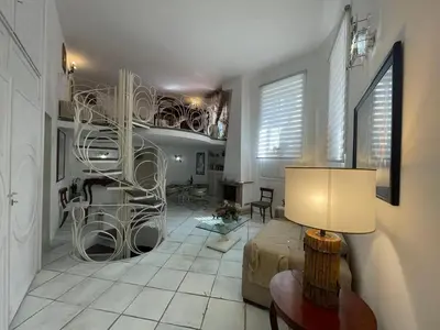 a living room with a spiral staircase in a room at Comfortable Apartment in the Heart of Rome, 65m², City View in Rome