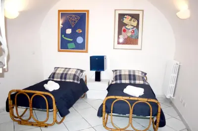 two beds in a room with white walls at Comfortable Apartment in the Heart of Rome, 65m², City View in Rome