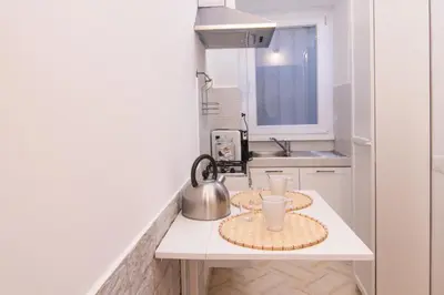 a kitchen with two plates and a tea kettle on a counter at Deluxe Suite Welness in Rome