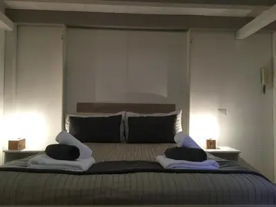 a bedroom with a large bed with two pillows at LE FATE STUDIO a San Pietro in Rome