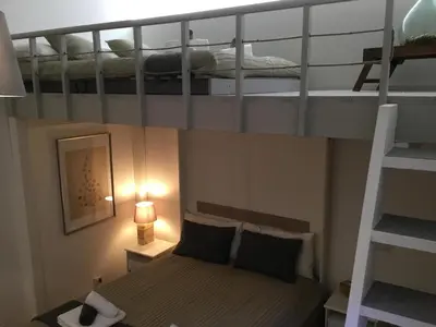 a small bedroom with two bunk beds and a lamp at LE FATE STUDIO a San Pietro in Rome