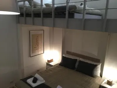 a bedroom with a bed with two bunk beds at LE FATE STUDIO a San Pietro in Rome
