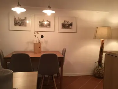 a dining room table with chairs and a lamp at LE FATE STUDIO a San Pietro in Rome