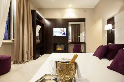 a hotel room with a tub and a bed at Roman Holidays Boutique in Rome