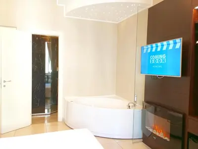 a living room with a fireplace and a tv at Roman Holidays Boutique in Rome