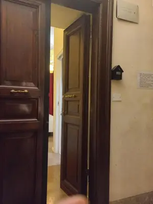 an open door in a room with a doorframe and a door at Stefano House Vaticano Roma in Rome