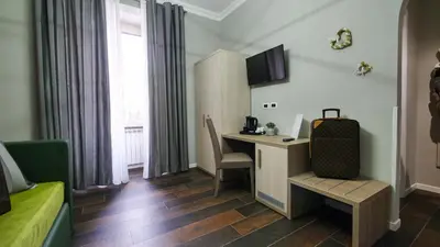 a hotel room with a desk and a computer in a room at Home Suites Giolitti in Rome