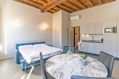 a living room with a table and a blue couch at The Pantheon Eyes in Rome