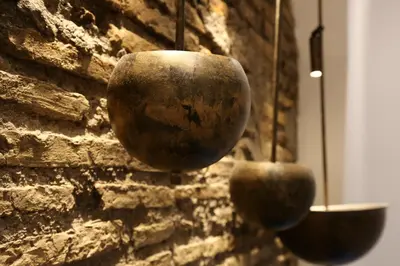 two pots are hanging on a brick wall at Old Town Home Trastevere in Rome