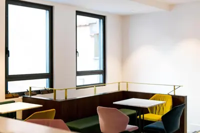 a room with tables and chairs and windows at Old Town Home Trastevere in Rome