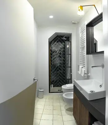 a white bathroom with a toilet and a sink at Old Town Home Trastevere in Rome