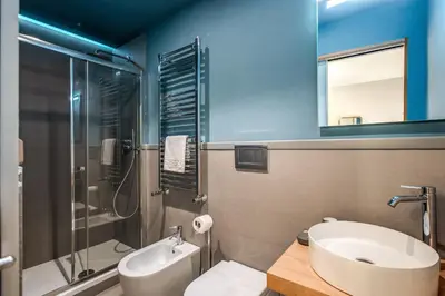 a bathroom with a sink and a toilet and a shower at Trevi Fountain Superior 3 bdr apartment in Rome