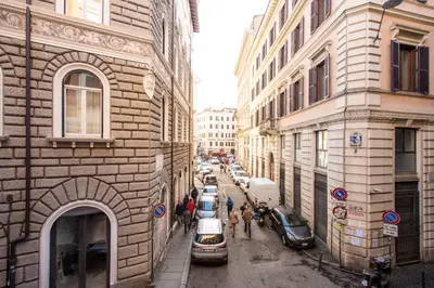a city street with cars parked next to buildings at Trevi Fountain Superior 3 bdr apartment in Rome