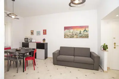 a living room with a couch and a table at Cosy Apartment 5 minutes from St Peter in Rome