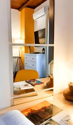 a room with a desk and a table with a mirror at Casa Flavia - Beauty apartment close to Vatican Museum in Rome