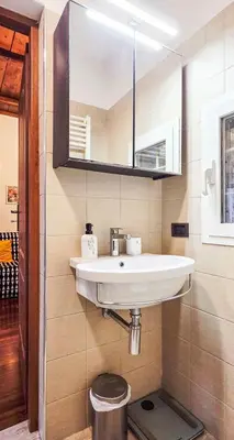 a bathroom with a white sink and a mirror at Casa Flavia - Beauty apartment close to Vatican Museum in Rome