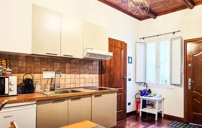 a kitchen with white cabinets and a sink at Casa Flavia - Beauty apartment close to Vatican Museum in Rome