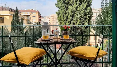 a small table with two chairs on a balcony at Casa Flavia - Beauty apartment close to Vatican Museum in Rome