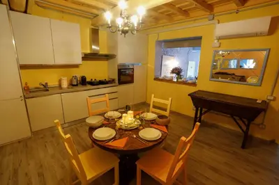 a kitchen and dining room with a table and a piano at Rome old town luxury loft in Rome