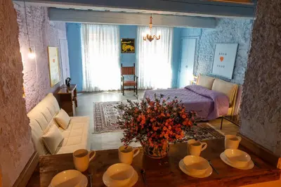 a living room with a couch and a table with flowers at Rome old town luxury loft in Rome