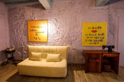 a white couch in a room with two pictures on the wall at Rome old town luxury loft in Rome
