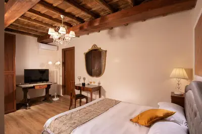 a bedroom with a bed and a desk at Residenza Nobile Laurina in Rome