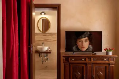 a television sitting on top of a dresser in a bathroom at Residenza Nobile Laurina in Rome