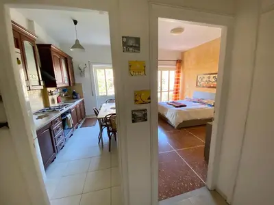 a room with a kitchen and a bedroom with a bed at Casa Alberto in Rome