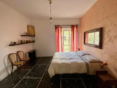 a bedroom with a bed and a window and chairs at Casa Alberto in Rome