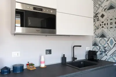 a kitchen with a sink and a microwave at Penthouse with Panoramic Terrace -3 Min to Metro A in Rome