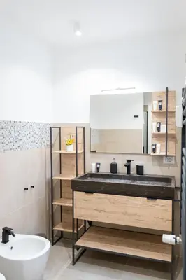 a bathroom with a sink and a mirror at Penthouse with Panoramic Terrace -3 Min to Metro A in Rome
