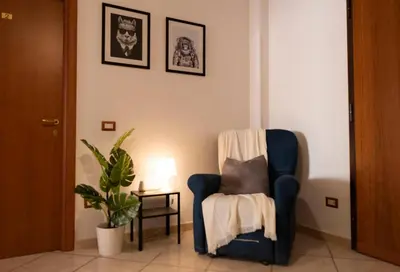 a living room with a chair and a plant at The Good Place B&B in Rome