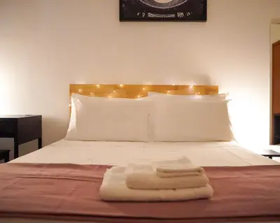 a bed with two towels sitting on top of it at The Good Place B&B in Rome