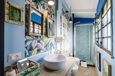 a bathroom with a large white bowl sink on a counter at Rome As You Feel - Torre Design Apartment in Rome