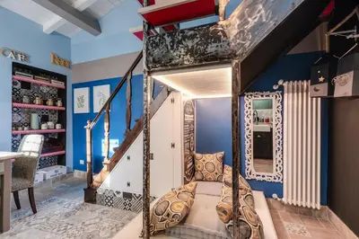 a bunk bed in a room with blue walls at Rome As You Feel - Torre Design Apartment in Rome
