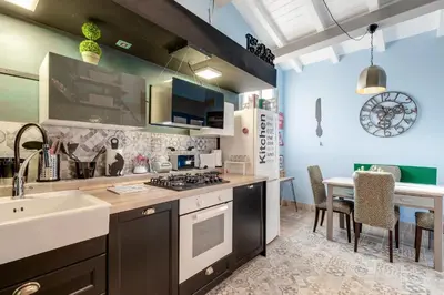 a kitchen with a sink and a stove top oven at Rome As You Feel - Torre Design Apartment in Rome