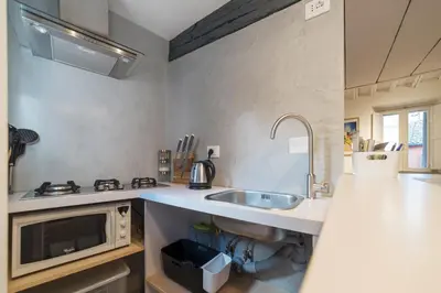 a kitchen with a sink and a microwave at GuestHost - Charming Loft Navona in Rome