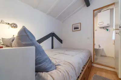 a bedroom with a bed with blue pillows on it at GuestHost - Charming Loft Navona in Rome