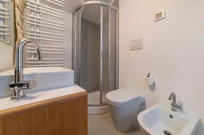 a bathroom with a toilet and a sink and a shower at GuestHost - Charming Loft Navona in Rome