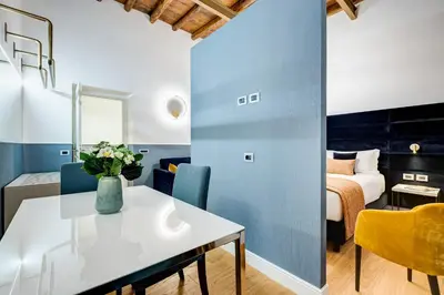 a room with a table and chairs and a bed at Glamour Studio - Spanish Steps in Rome