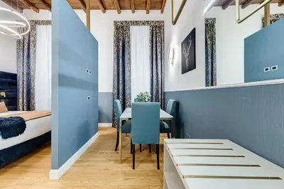 a room with a bed and a table and chairs at Glamour Studio - Spanish Steps in Rome